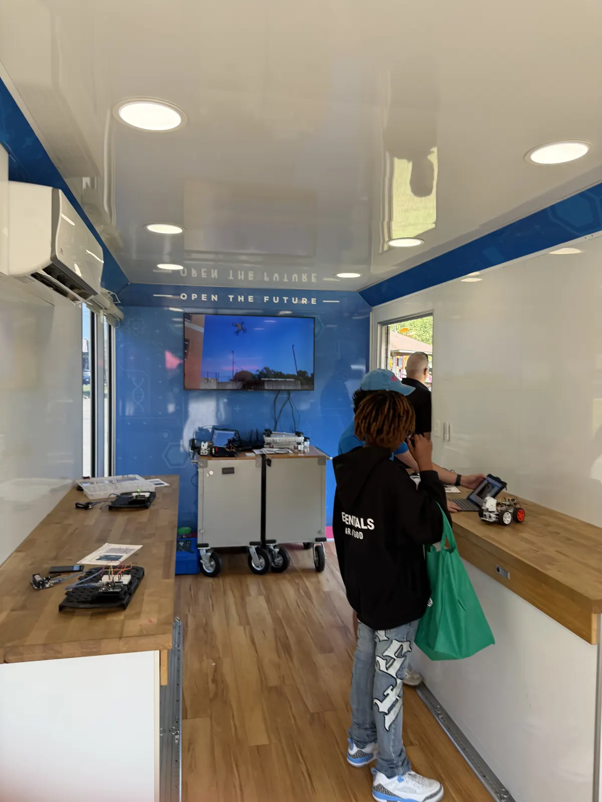 A robot car and laptops set up on the lab benches.