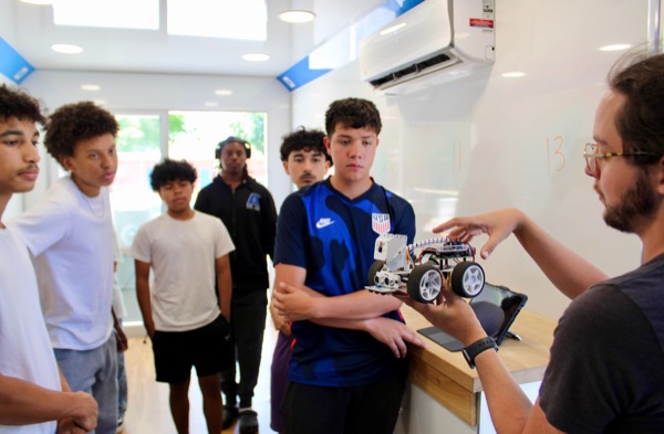 Betabox guide leading students through a robot car demo