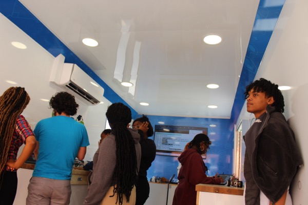 Students working at stations inside a Betabox mobile lab.